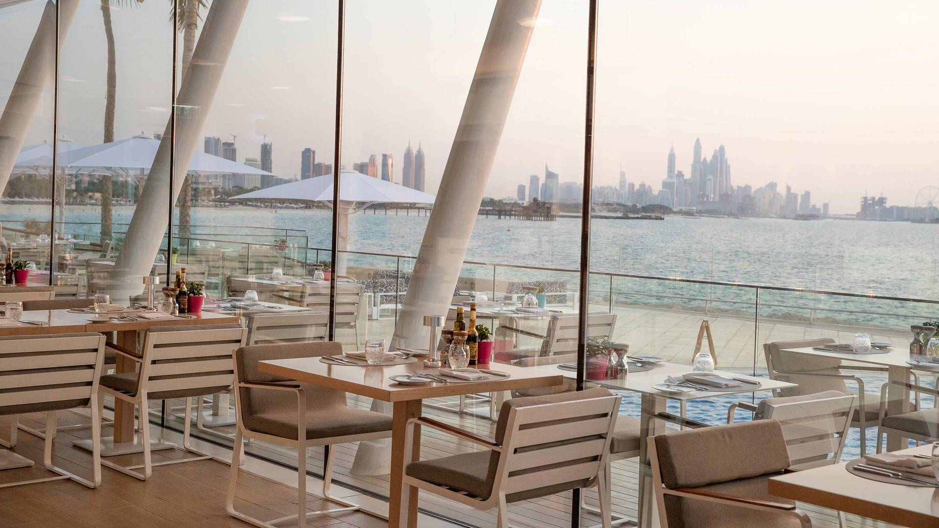 卓美亚帆船酒店 Bab Al Yam 餐厅，可欣赏海滩和城市景观。
